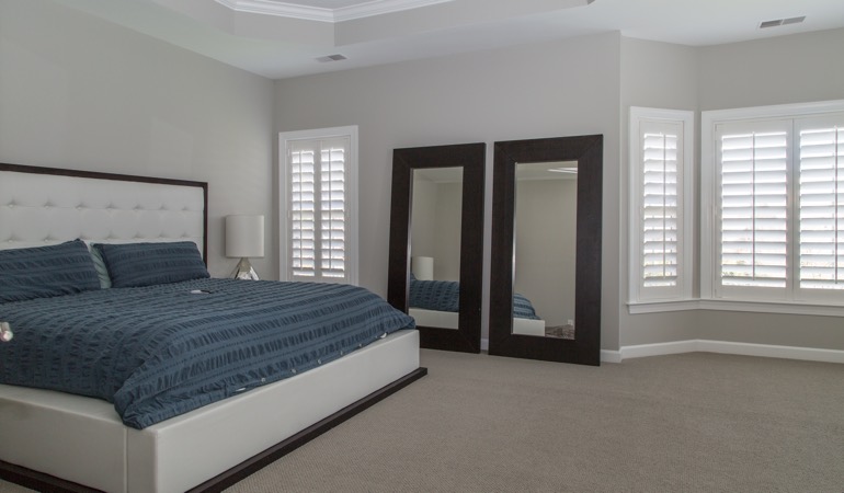 Polywood shutters in a minimalist bedroom in Las Vegas.